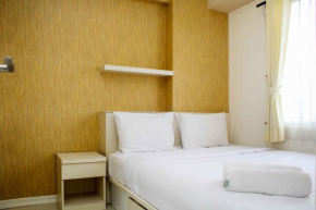 Minimalist and Warm 2BR Bassura City Apartment By Travelio